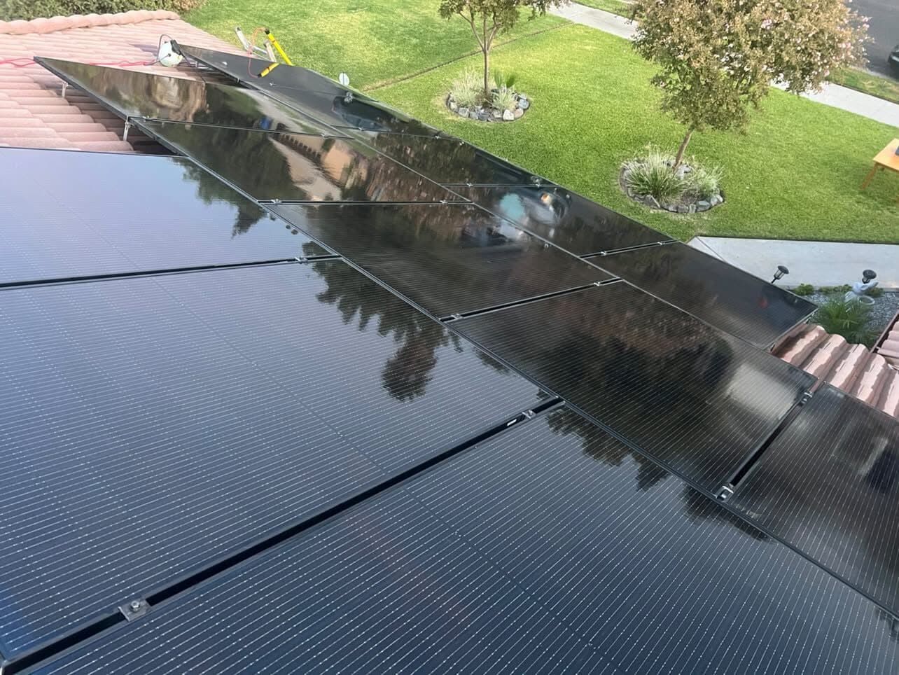 Elevated view of a cleaned solar array in daylight with the yard below